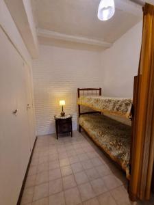 a room with two bunk beds and a lamp on a table at Casa Mardel in Mar del Plata