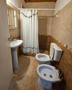a bathroom with a toilet and a sink at Casa Mardel in Mar del Plata