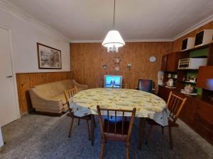 a living room with a table with chairs and a couch at Casa Mardel in Mar del Plata