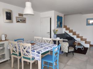 a dining room with a table and chairs and a staircase at Villa Nono in Vrh
