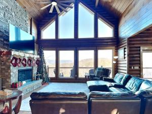 a living room with a couch and a fireplace at 5 Solas Lodge in Sevierville +42 photos