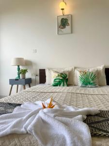 a bedroom with a bed with a white blanket at Platinum - Sun-kissed Holidays Goa in Dabolim +55 photos