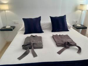 a bed with two shirts and ties on it at La Repera Jaén in Jaén
