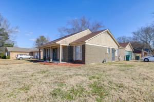 a house with a car parked in a yard at 4 Mi to Shelby Farms Park Memphis Home with Patio! in Memphis