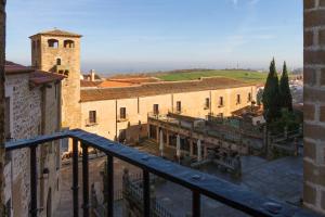 a view of a city from a balcony of a building at Hostel Casa Vargas Figueroa in Cáceres