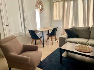 a living room with a couch and chairs and a table at La Repera Jaén in Jaén