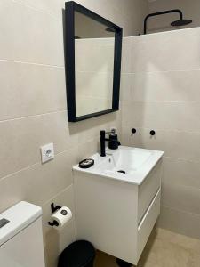 a bathroom with a white sink and a mirror at La Repera Jaén in Jaén +10 photos