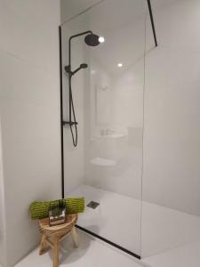 a bathroom with a shower with a bench and a lamp at Apartamento Diseño Myrtus in Ponteareas