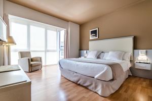 Postel nebo postele na pokoji v ubytování Hotel Nagusi