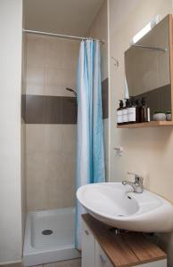 a bathroom with a sink and a shower at Seafront 4-Bedroom Townhouse with Panoramic Views in Iż-Żlielaq