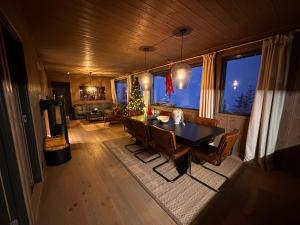 ein Esszimmer mit einem Tisch und Stühlen in einem Raum in der Unterkunft Hafjell Front 8pers Ski InOut in Hunder