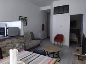 a living room with a couch and a table at Chalet Elaïa in Eaux-Bonnes +2 photos