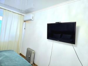 a room with a flat screen tv on the wall at Двухкомнатная "Аэропорт Астана" in Prigorodnyy