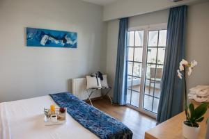 Postel nebo postele na pokoji v ubytování Kronos Hotel