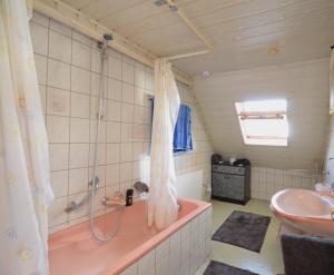 a bathroom with a pink tub and a sink at Monteurzimmer fitter room Apartment Bruchsal Heilbronn Bretten in Oberderdingen