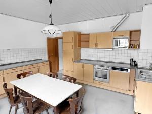 a kitchen with a white table and a table and chairs at Monteurzimmer fitter room Apartment Bruchsal Heilbronn Bretten in Oberderdingen