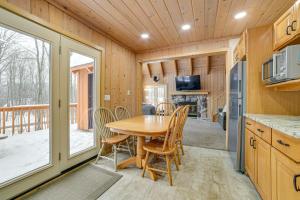 a kitchen and dining room with a table and chairs at Less Than 1 Mi to Nubs Nob Ski Cabin with Sauna and Deck! in Harbor Springs