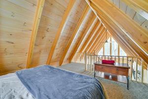 a bedroom with a bed and a desk in a attic at Less Than 1 Mi to Nubs Nob Ski Cabin with Sauna and Deck! in Harbor Springs