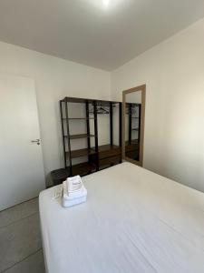 a room with a large white bed with a mirror at TrevizZo Catedral da Sé in São Paulo +14 photos