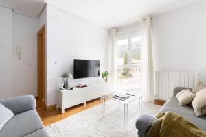 a living room with a couch and a tv at Yesa by Clabao in Yesa
