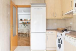 a white refrigerator in a kitchen with a table at Yesa by Clabao in Yesa