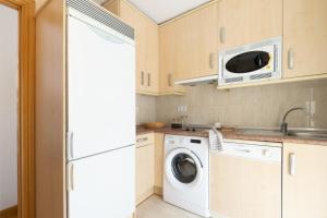 a kitchen with a washing machine and a sink at Yesa by Clabao in Yesa +17 photos