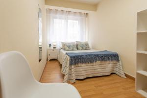 A bed or beds in a room at Apartamento Centro Santiago