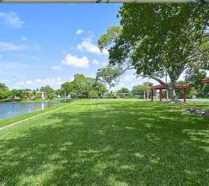 a park with a tree and a gazebo and water at 1233 Apartment 3 Miami in Tamiami