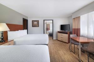 a hotel room with a bed and a desk at Best Western Red Hills in Kanab