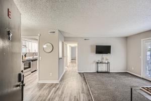 an empty living room with white walls and a kitchen at Crest At East Cobb1820e Comfort, Spacious 2bd 2bt in Marietta