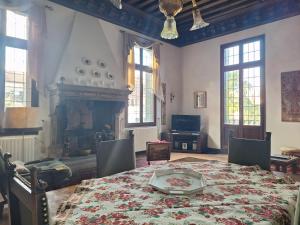a dining room with a table and a fireplace at Appartamenti inside Palazzo Foscarini in Venice