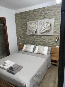 a bedroom with a bed and a stone wall at Raggio di Sole in Iglesias