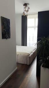 a bedroom with a bed in a room with a window at Spacious 2-Bedroom Apartment Near City Center in Berlin