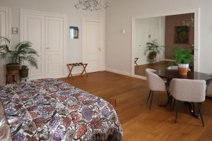 a bedroom with a bed and a table and a dining room at Bij Joseph in Den Bosch +5 photos