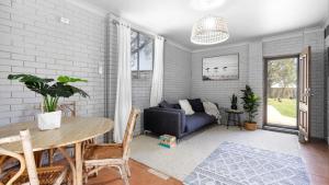 a living room with a table and a couch at Casa Blu in Culburra Beach