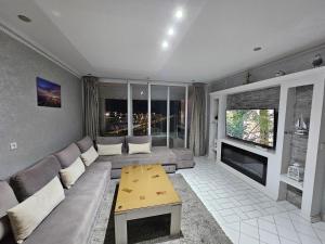 a living room with a couch and a fireplace at Panoramic Sea View Apartment 1 Min Walk to Beach in Tangier +40 photos