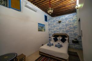 Postel nebo postele na pokoji v ubytování Riad bab merzouga