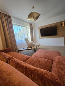 TV a/nebo společenská místnost v ubytování Massif Grand Chalet Apartments + 58 fotografií