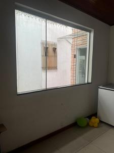 a room with a large window with yellow balls on the floor at casacop30belem in Belém