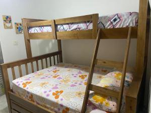 two bunk beds in a room with a bed at Edifício Bandeirantes in Praia Grande