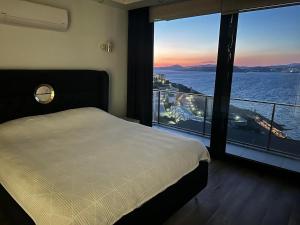 a bedroom with a bed and a view of the water at Villa Paradise in Milas +78 photos