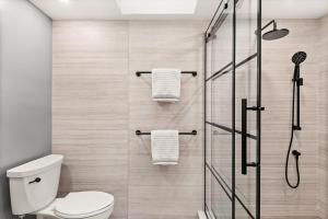 a bathroom with a shower with a toilet and towels at Family Snowmass Getaway Minutes To Ski & Village - 229 #36 in Snowmass Village