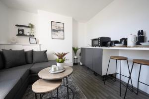 a living room with a couch and a kitchen at 1BR Flat in Centre - Sleeps 3 in Kent