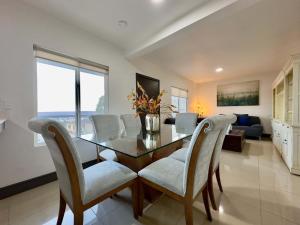 a dining room with a glass table and chairs at 2 Story Condo TJ 3BDR 3BR in Tijuana