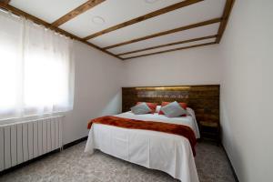 a bedroom with a large bed and a window at Apartments Mo in Monistrol