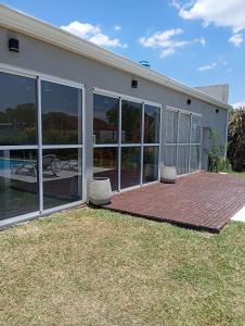a house with large windows and a patio at Quincho El Solar in Corrientes +22 photos
