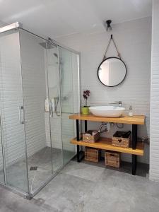 a bathroom with a glass shower and a sink at Mazagón Pez de Plata in Mazagón