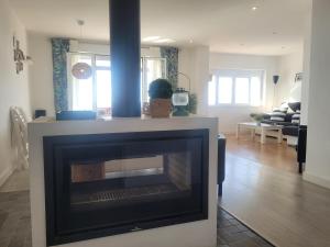 a living room with a fireplace in the middle of it at Mazagón El Pez de Plata in Mazagón
