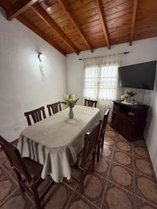 a dining room with a table with chairs and a television at Casa Mar de Cobo in Mar de Cobo +3 photos
