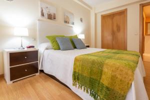 A bed or beds in a room at Apartamento Centro Santiago
